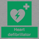 green-background-with-white-text-and-heart-defibrillator-symbol--white-cross-and~